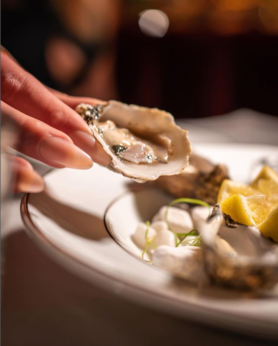 Guests enjoying oysters at a private event at ADKT, the best French-Japanese fusion restaurant in LA